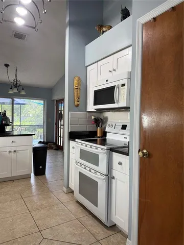 a kitchen with a stove a sink and a refrigerator