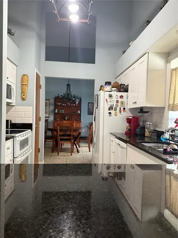 a kitchen with stainless steel appliances granite countertop a stove and a refrigerator