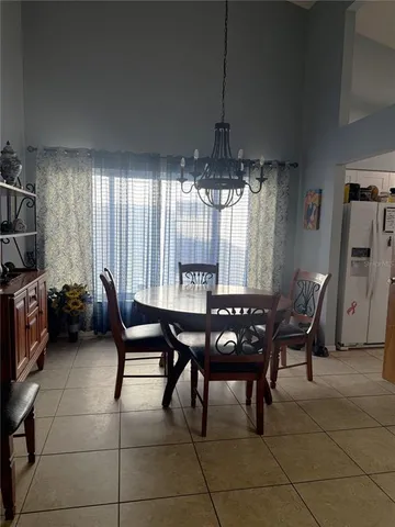 a view of a dining room with furniture and chandelier