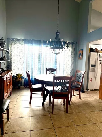 a view of a dining room with furniture and chandelier