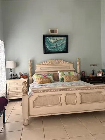 a bedroom with a bed and a painting on the wall
