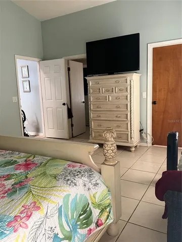 a bedroom with a bed and a television