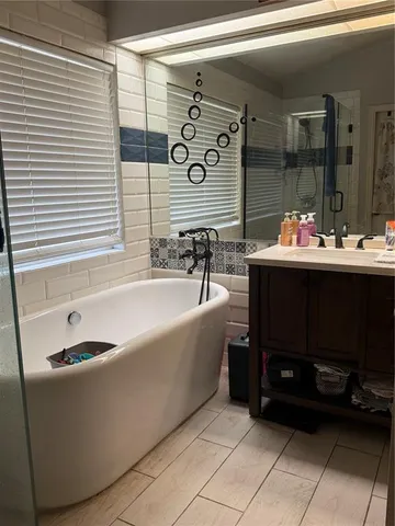 a bathroom with a bathtub and shower