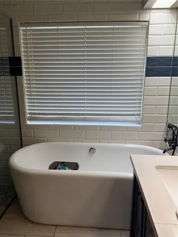 a bathroom with a bathtub and a sink
