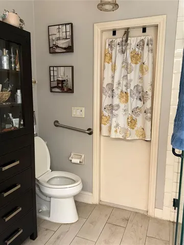 a white toilet sitting next to a bathroom sink