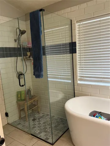 a bathroom with a bathtub and shower