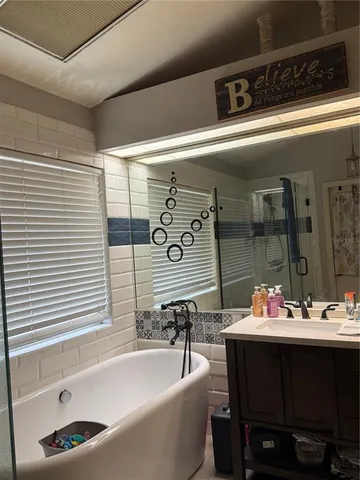 a bathroom with a bathtub and a sink