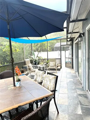 a view of an outdoor dining space with a table and chairs