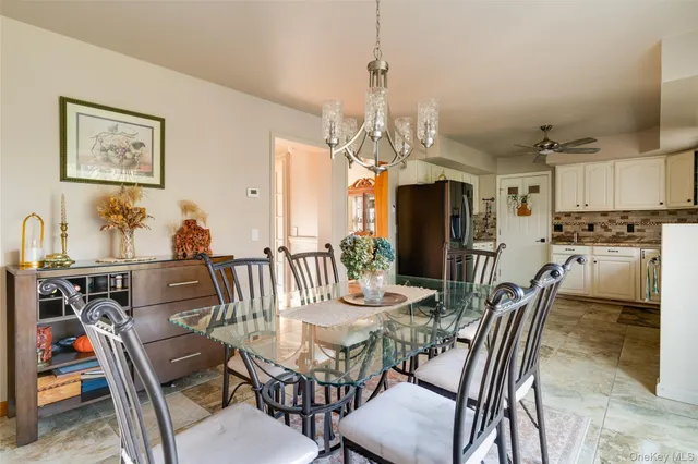a view of a dining room with furniture and a chandelier