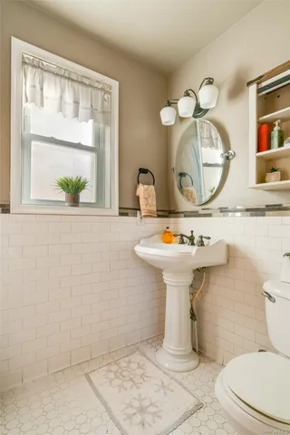 a bathroom with a sink toilet and mirror