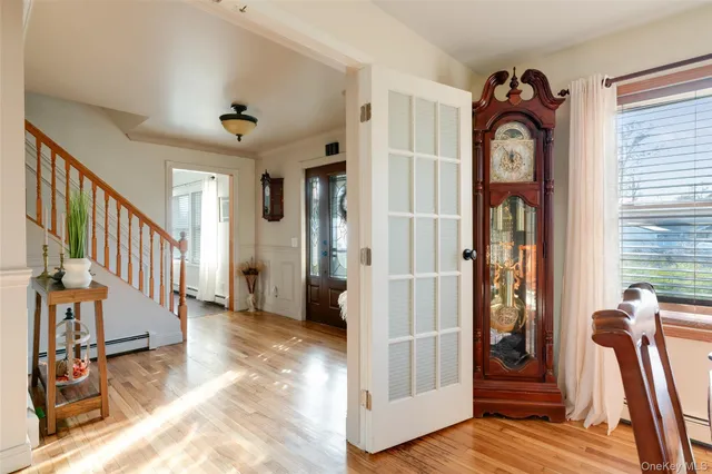 a view of an entryway with wooden floor and stairs