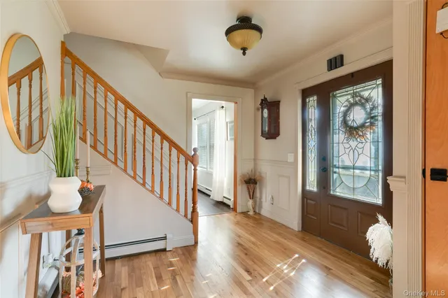 a view of an entryway with wooden floor and windows