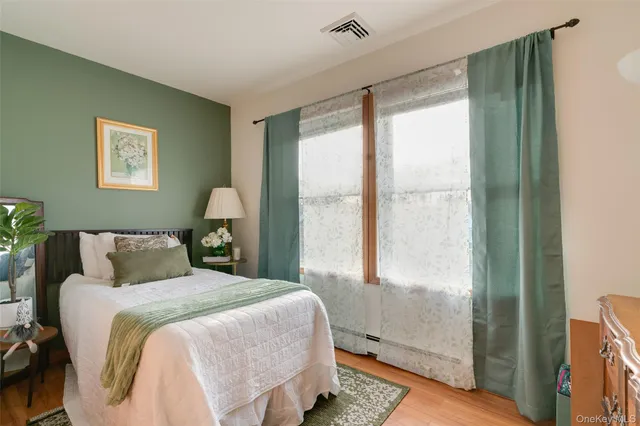 a bedroom with a large bed and a window