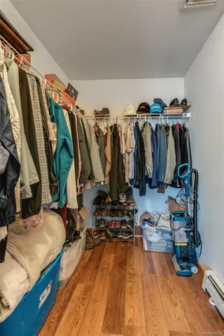a view of walk in closet with clothes and shoes