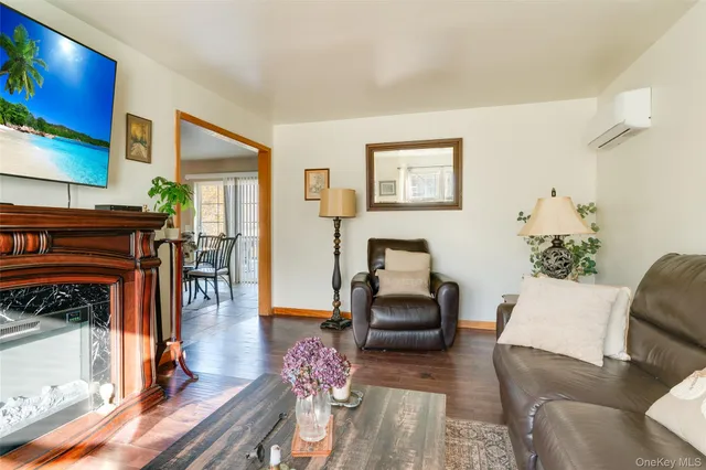 a living room with furniture a piano and a fireplace