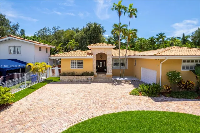 a front view of a house with a yard and outdoor seating
