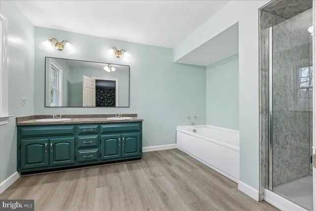 a bathroom with a sink double vanity and a mirror