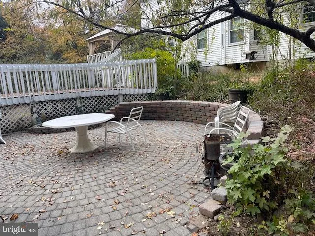 a white bench sitting in front of a house