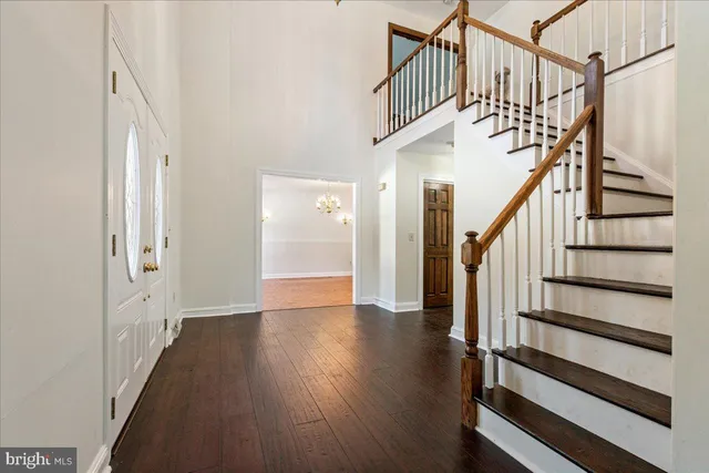 a view of entryway with wooden floor and stairs
