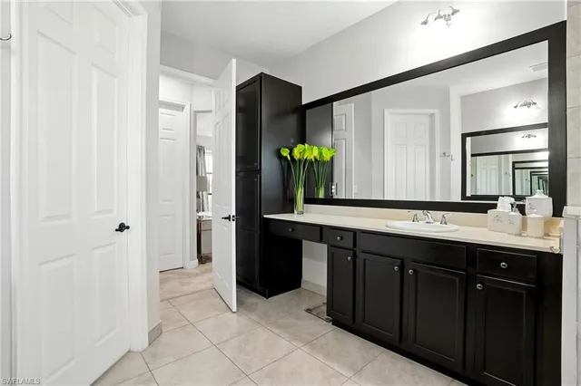 a spacious bathroom with a double vanity sink and a mirror