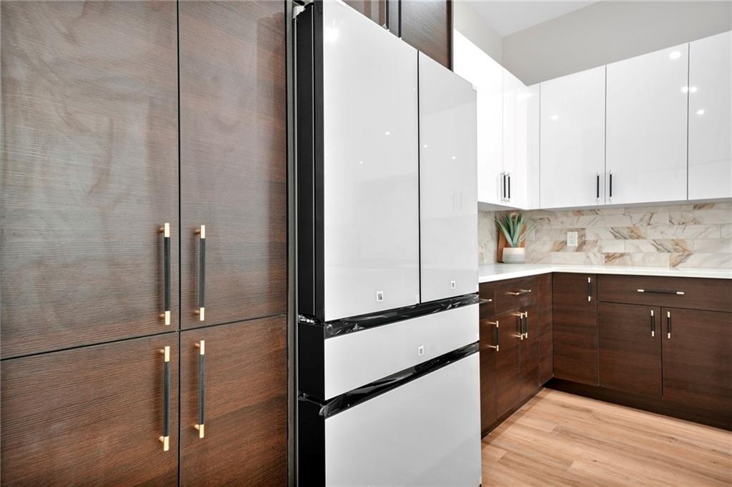 237 Altoona Place Southwest Atlanta, GA 30314 - Photo 22 of 63 a kitchen with a refrigerator and cabinets