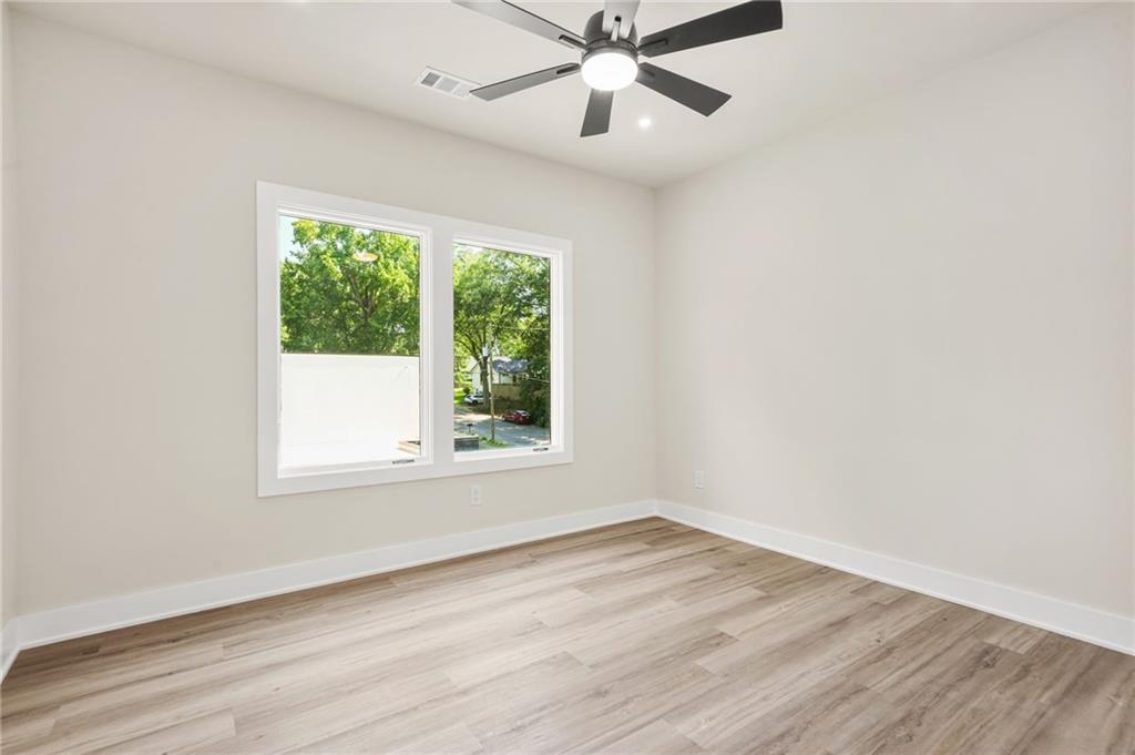 237 Altoona Place Southwest Atlanta, GA 30314 - Photo 43 of 63 an empty room with wooden floor fan and windows