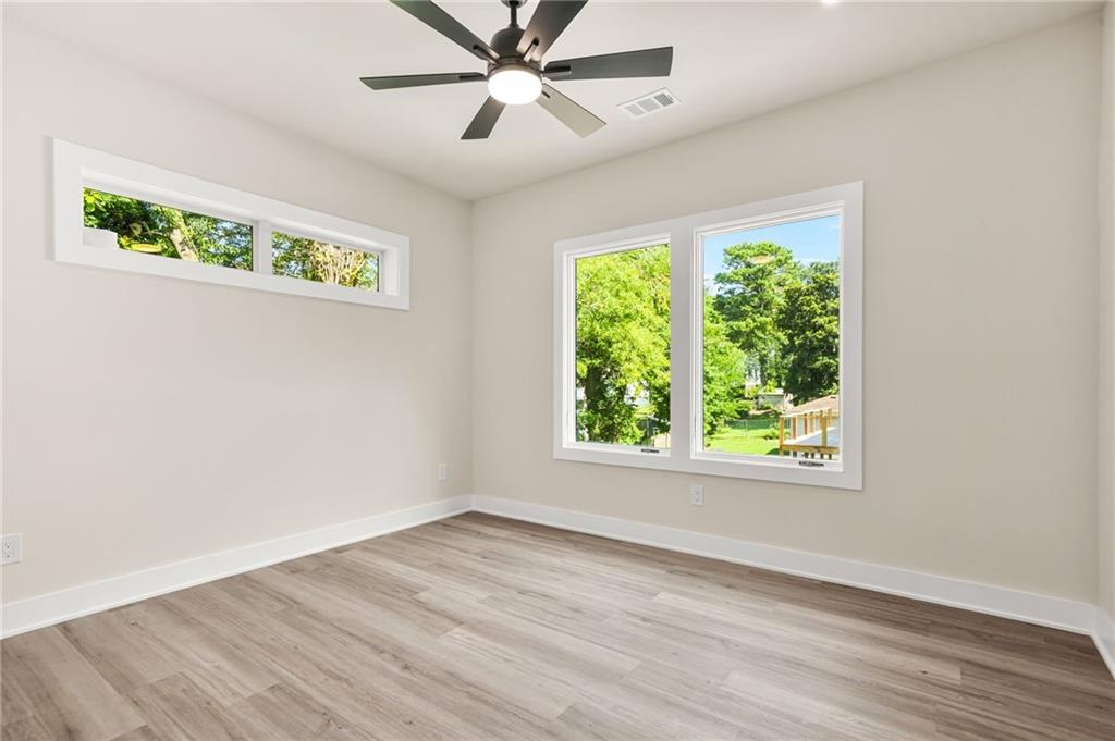 237 Altoona Place Southwest Atlanta, GA 30314 - Photo 45 of 63 an empty room with wooden floor fan and windows