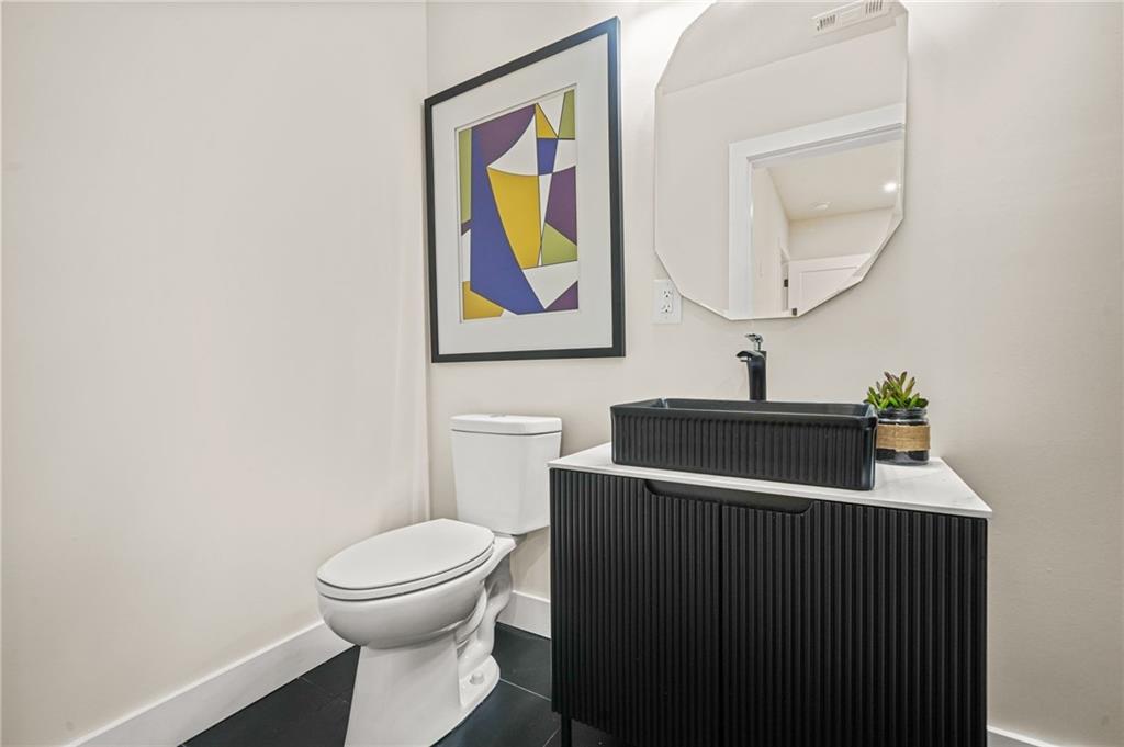 237 Altoona Place Southwest Atlanta, GA 30314 - Photo 55 of 63 a bathroom with a toilet a sink and mirror
