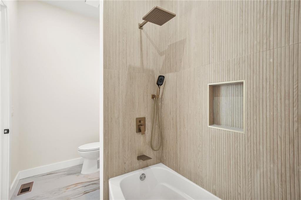 237 Altoona Place Southwest Atlanta, GA 30314 - Photo 6 of 63 a bathroom with a white bath tub a toilet and a sink