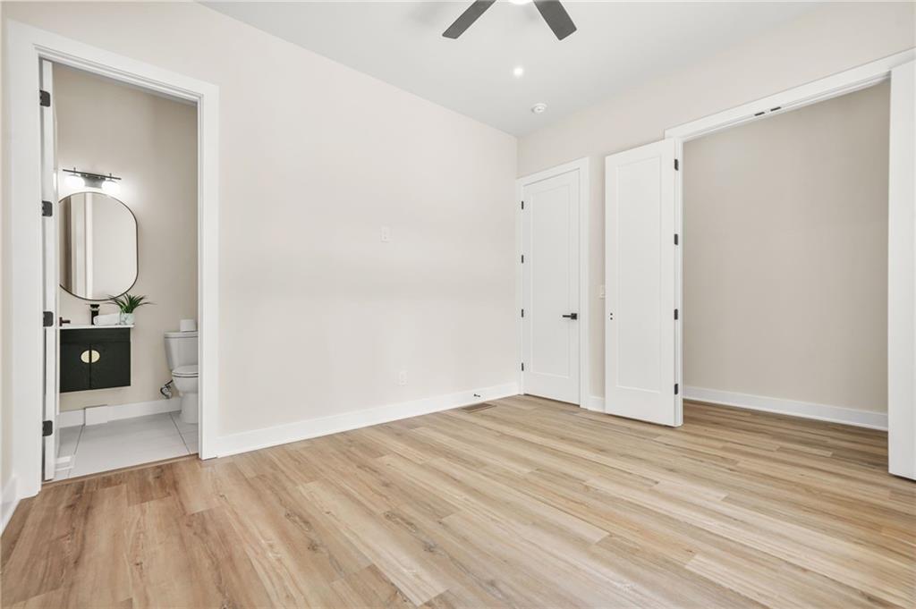 237 Altoona Place Southwest Atlanta, GA 30314 - Photo 8 of 63 an empty room with wooden floor and mirror