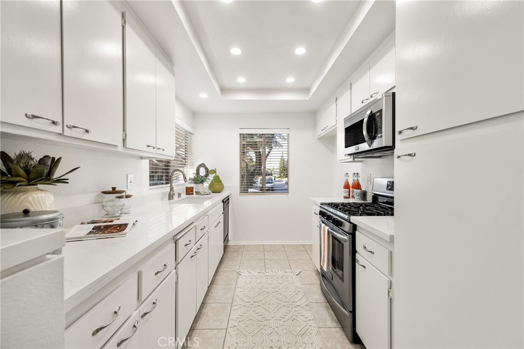 126 Clearbrook Irvine, CA 92614 - Photo 14 of 44 a kitchen with stainless steel appliances granite countertop a sink and cabinets