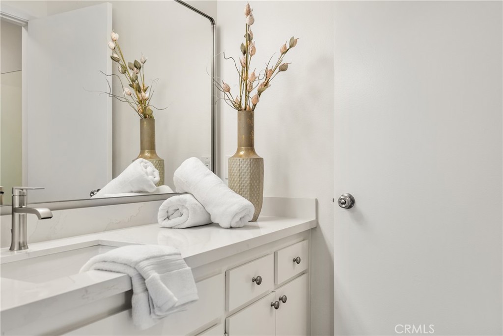 126 Clearbrook Irvine, CA 92614 - Photo 18 of 44 a bathroom with a double vanity sink and a mirror