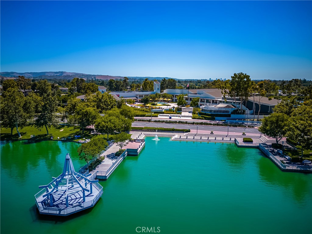 126 Clearbrook Irvine, CA 92614 - Photo 37 of 44 a view of a swimming pool with lawn chairs under an umbrella