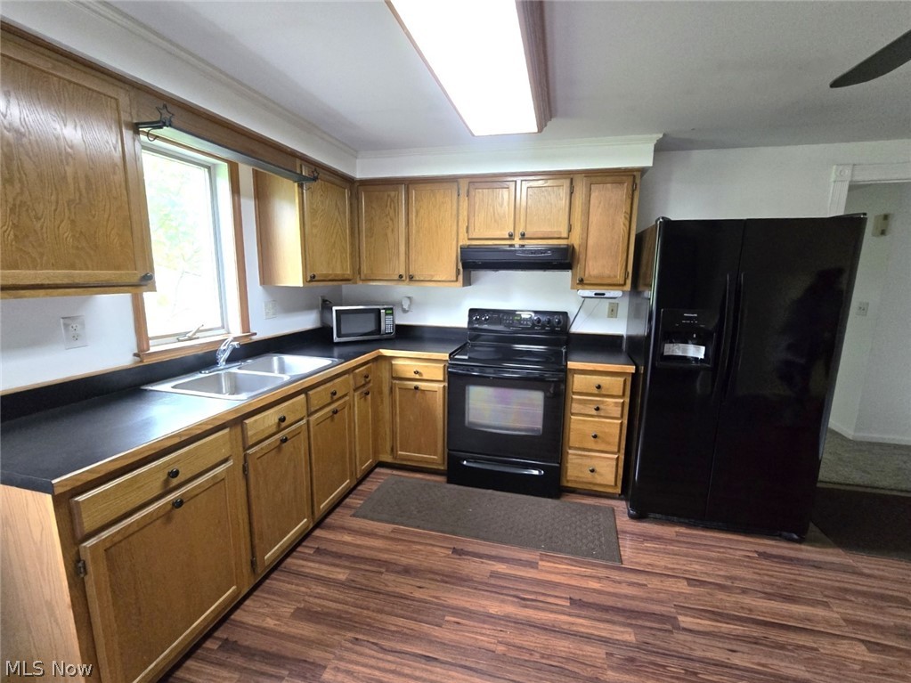 28365 Osborne Road Coolville, OH 45723 - Photo 13 of 49 Kitchen featuring wood-finish flooring, wood cabinetry, a dual basin stainless steel sink, black countertops, and a black side-by-side refrigerator