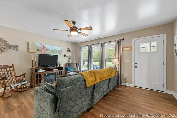 a living room with furniture and a flat screen tv
