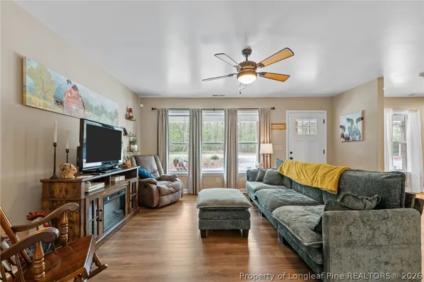 a living room with furniture and a flat screen tv