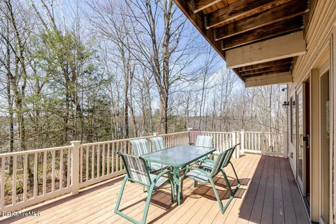 a view of a patio with iron fence