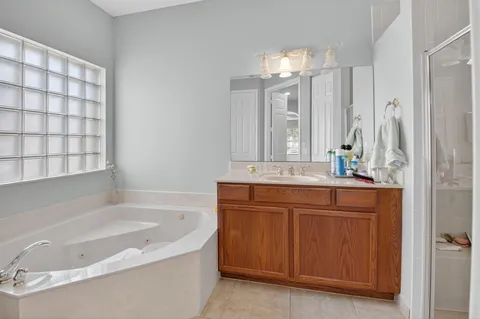 a bathroom with a double vanity sink mirror and shower