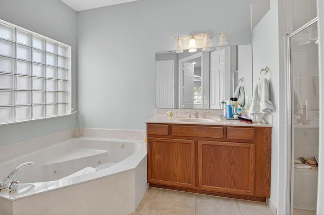 a bathroom with a double vanity sink mirror and shower