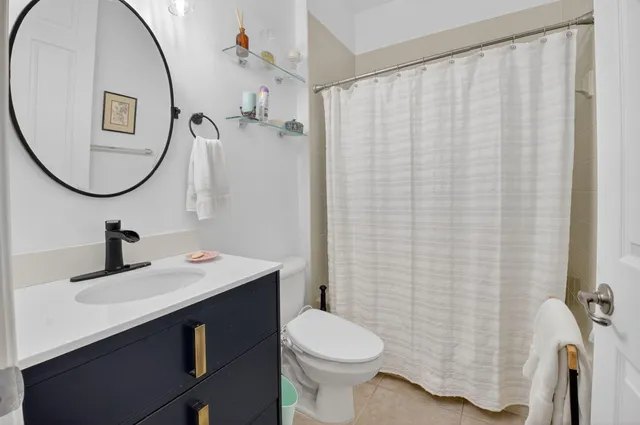a view of a patio with couches plants and garden