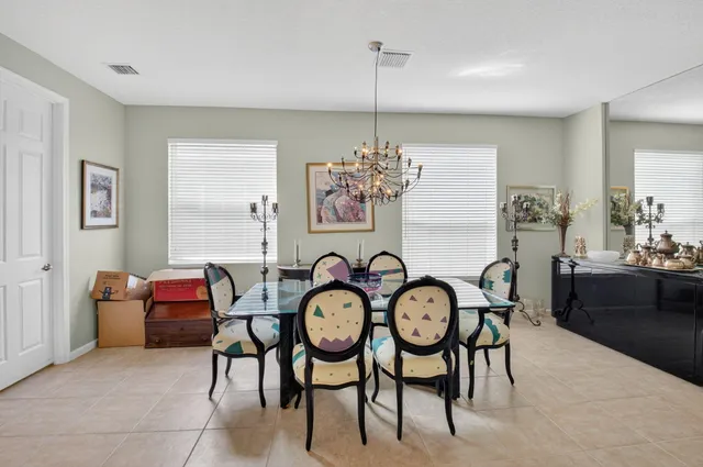 a view of a dining room with furniture wall and a chandelier