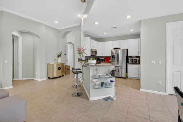 a view of kitchen with refrigerator and cabinets