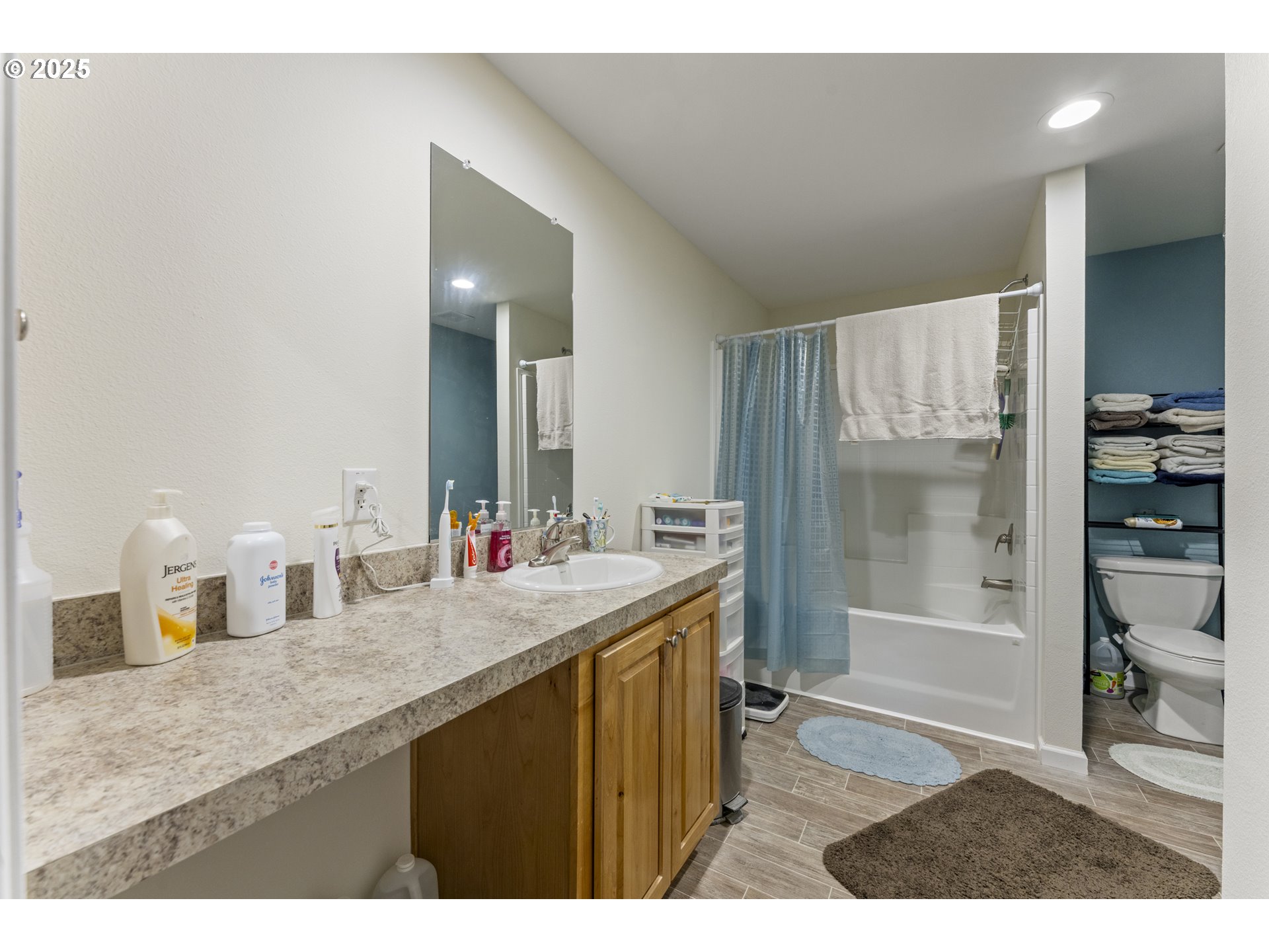 69127 Wildwood Road, Unit 4 North Bend, OR 97459 - Photo 14 of 20 a bathroom with a granite countertop sink a toilet a mirror and shower