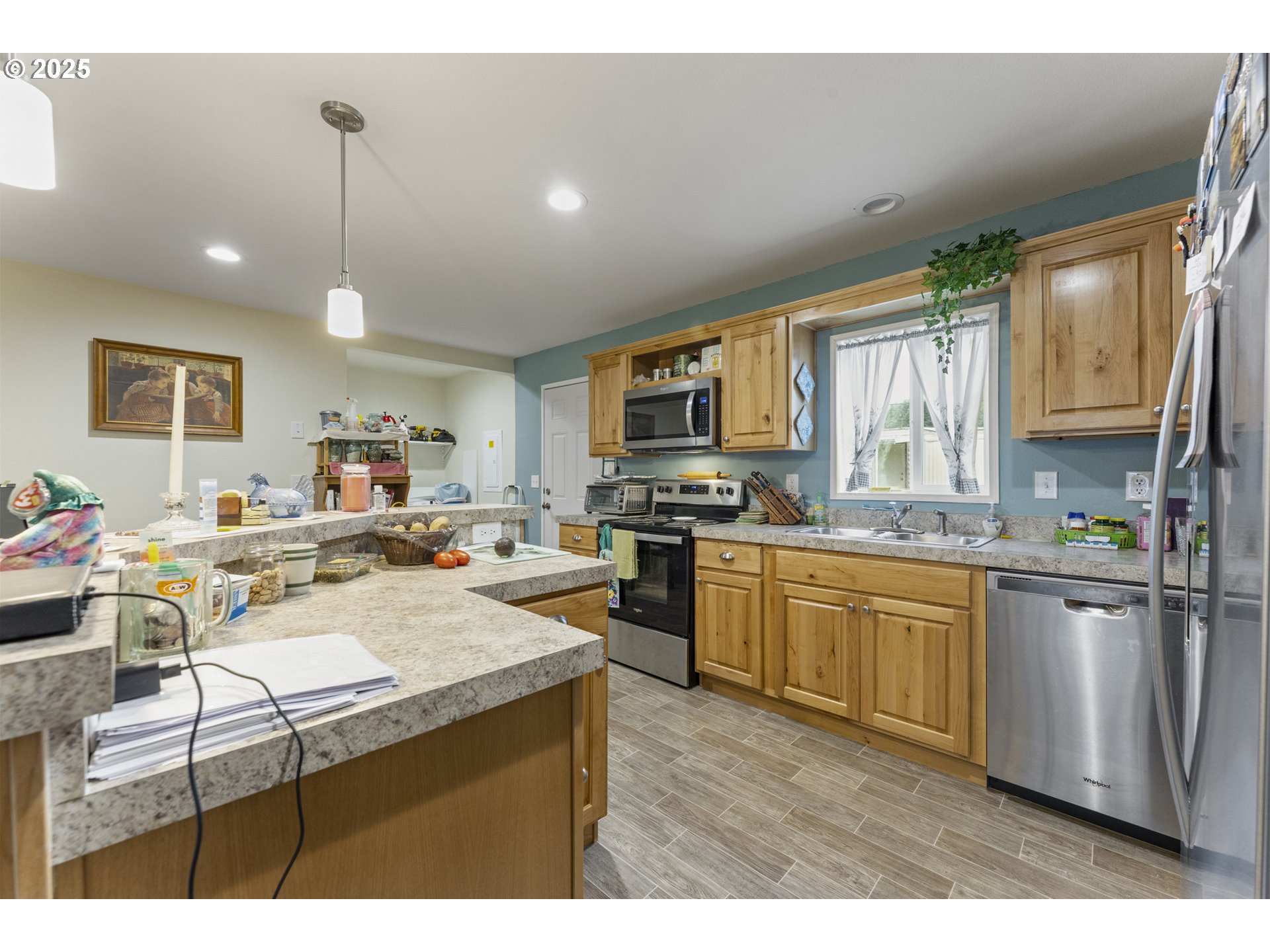 69127 Wildwood Road, Unit 4 North Bend, OR 97459 - Photo 10 of 20 a kitchen with a sink a stove a refrigerator cabinets and a dining room