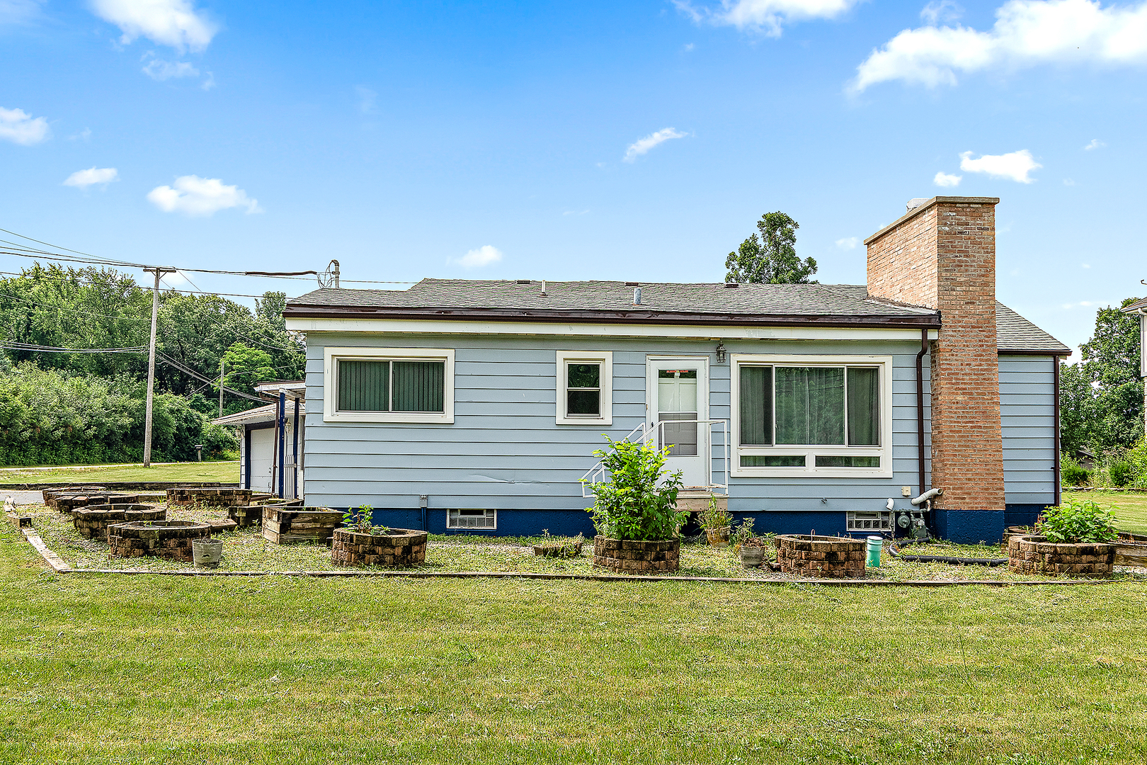 a view of a house with a backyard porch and sitting area