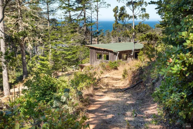 a backyard of a house with yard barbeque oven and outdoor seating