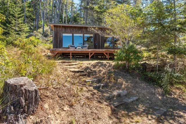 a view of balcony with wooden floor and outdoor seating