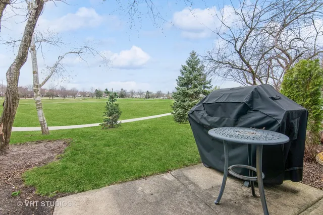 a view of a chairs and table in backyard of the house