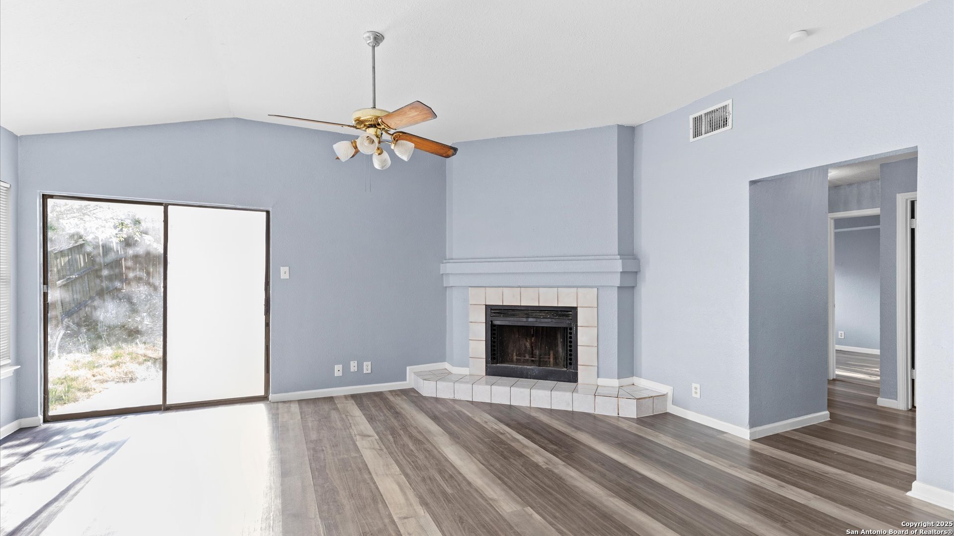 8622 Ridge Flower San Antonio, TX 78239 - Photo 4 of 19 a living room with a fireplace furniture and a window