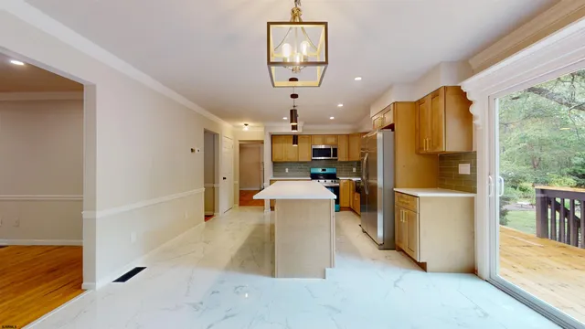 a view of an empty room and wooden floor